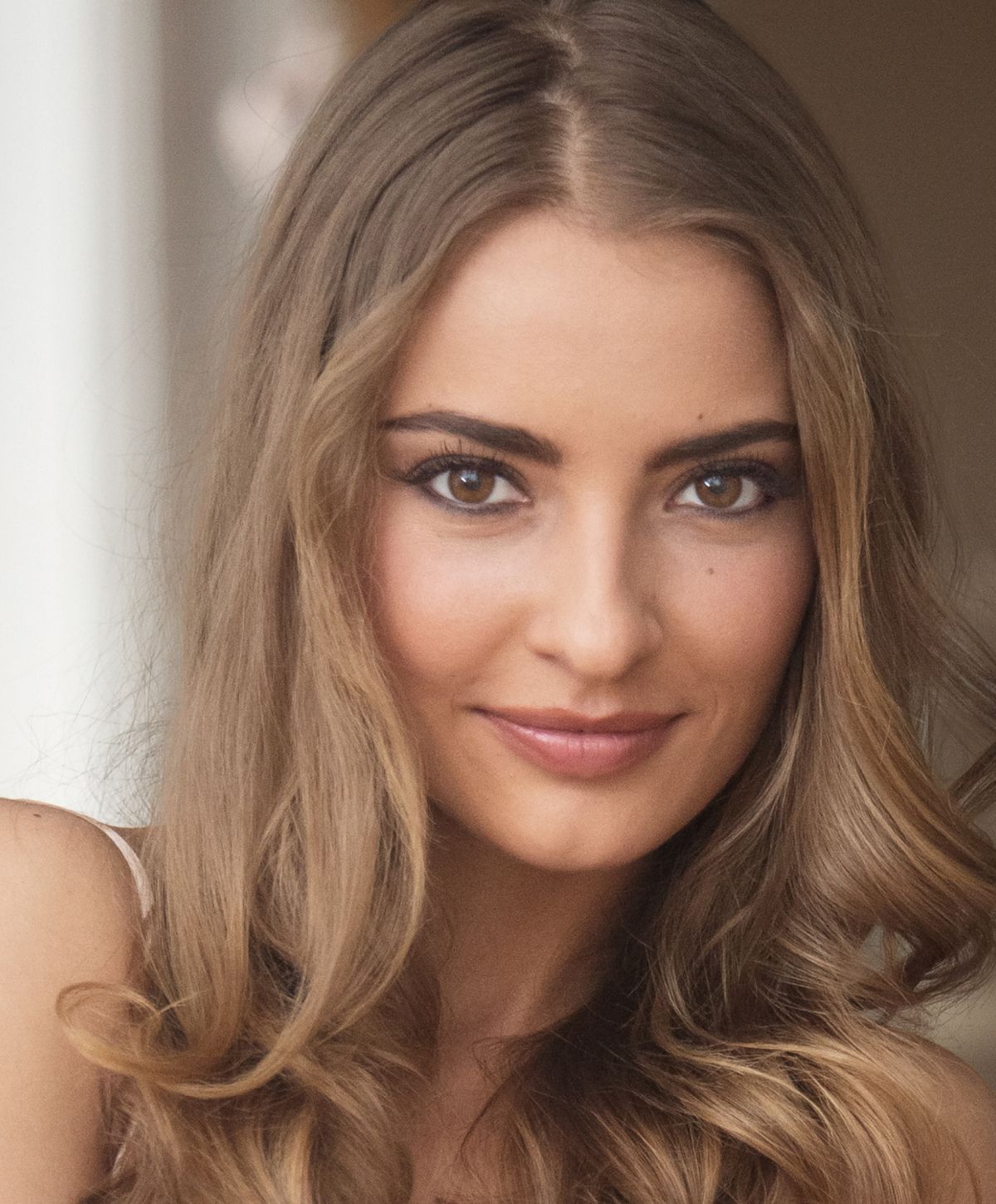 Portrait of a young woman with wavy hair.