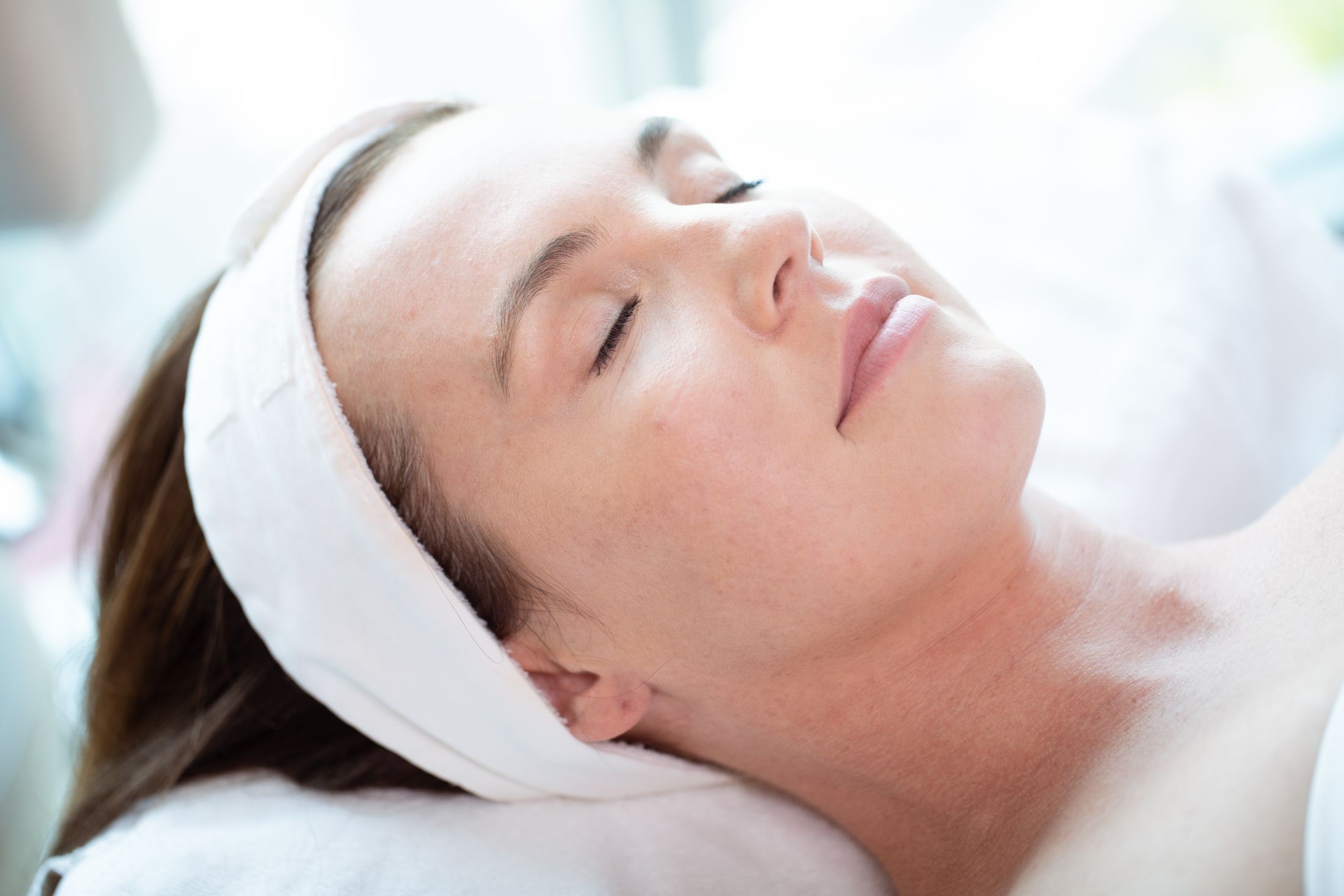 Person relaxing during a skincare treatment session.