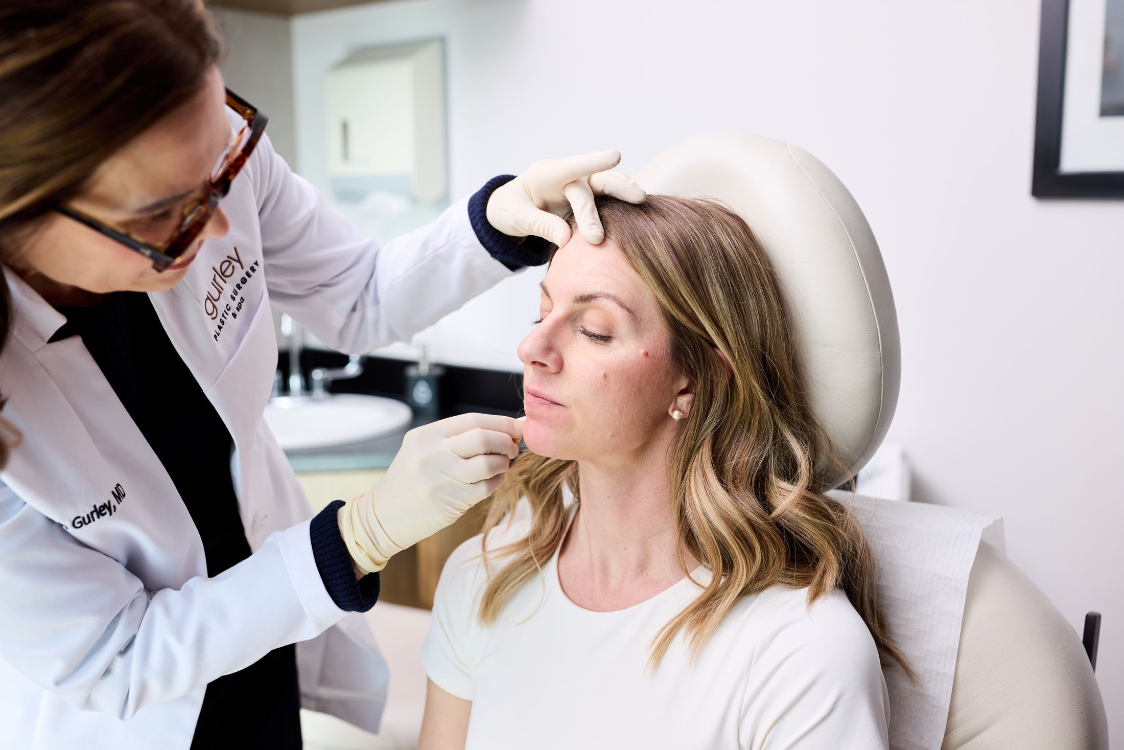 Patient receiving facial treatment in a clinic.