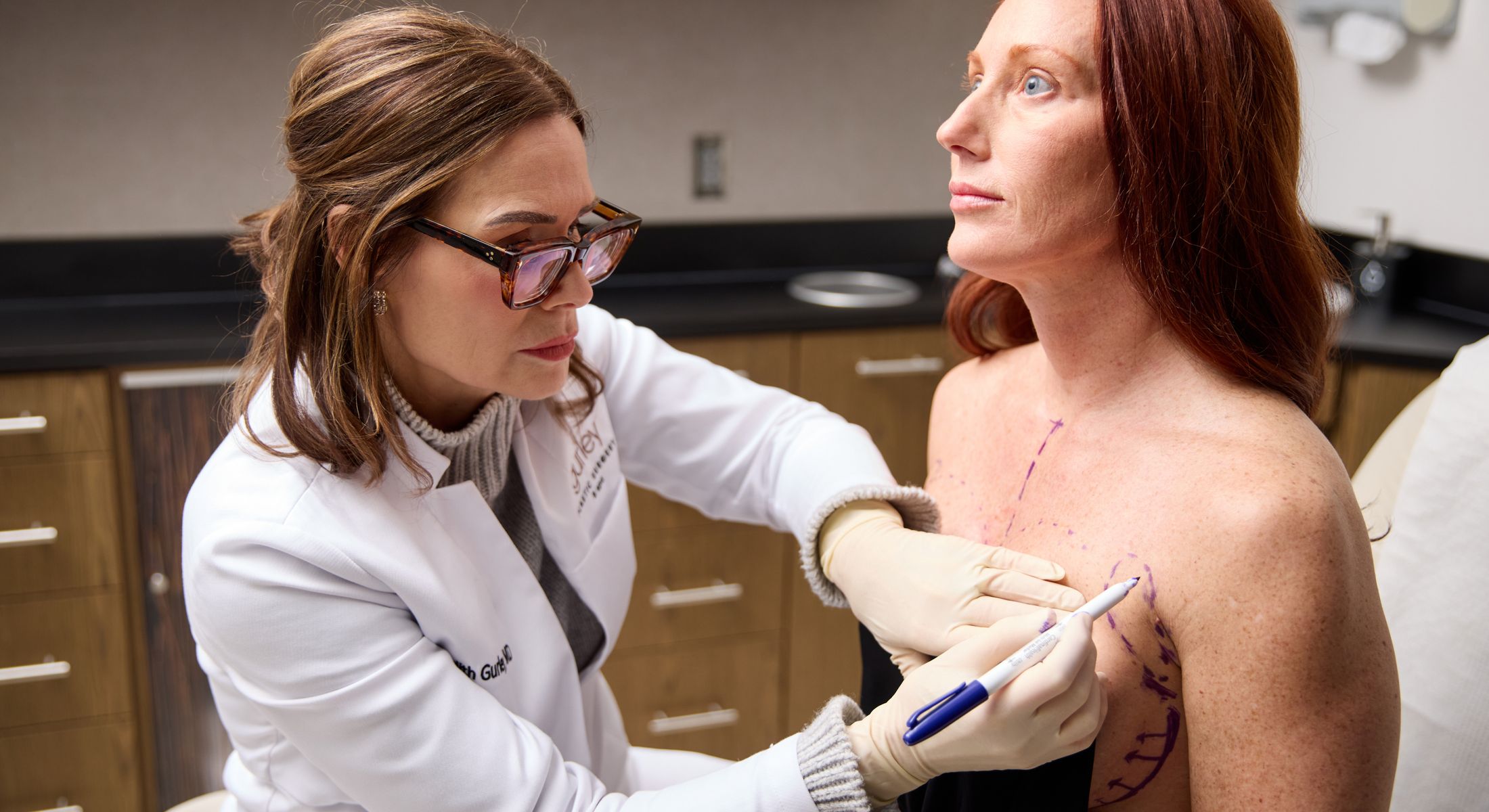 Doctor marking patient’s skin for a procedure.