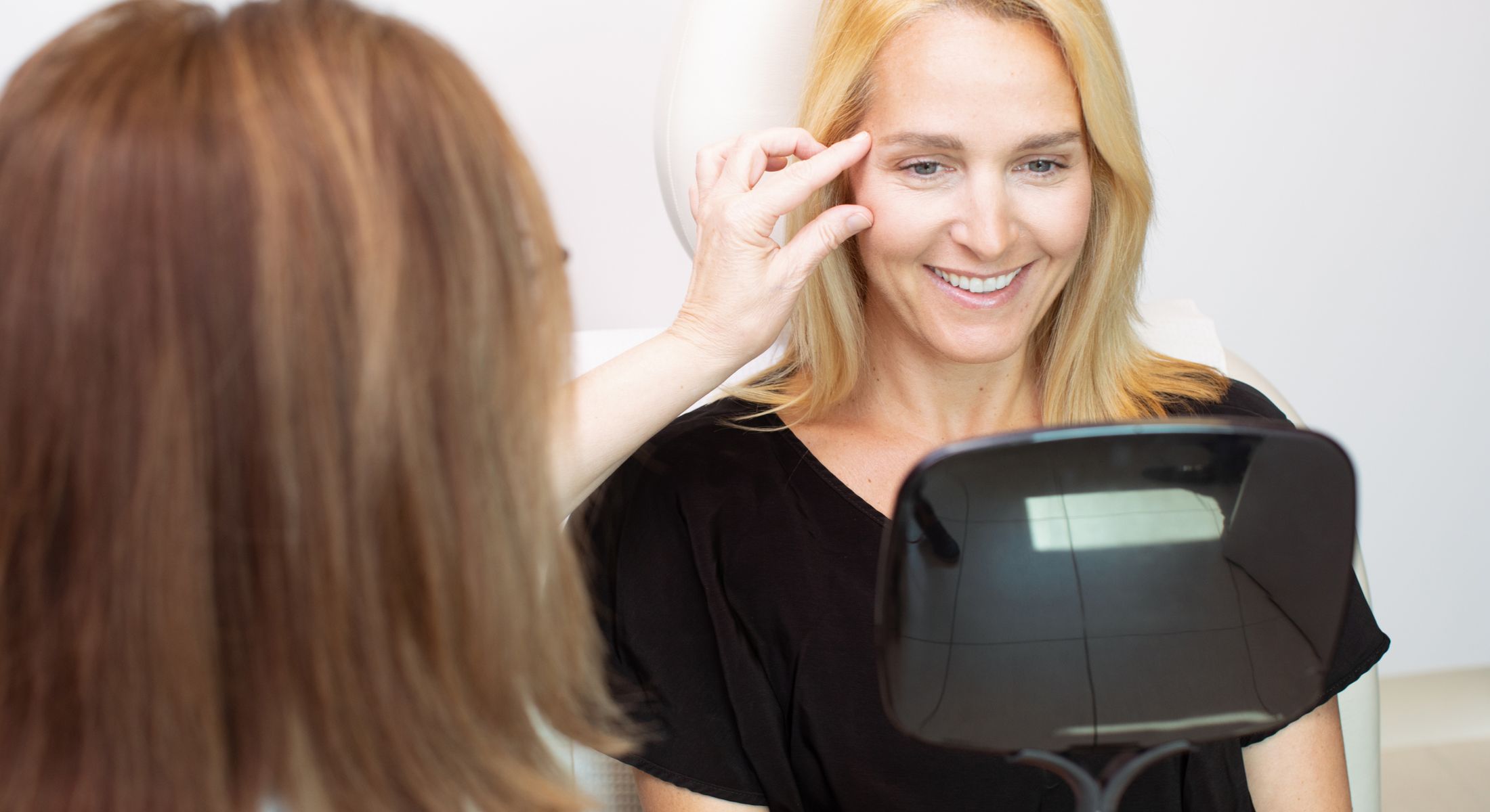 Woman smiling in consultation with specialist.