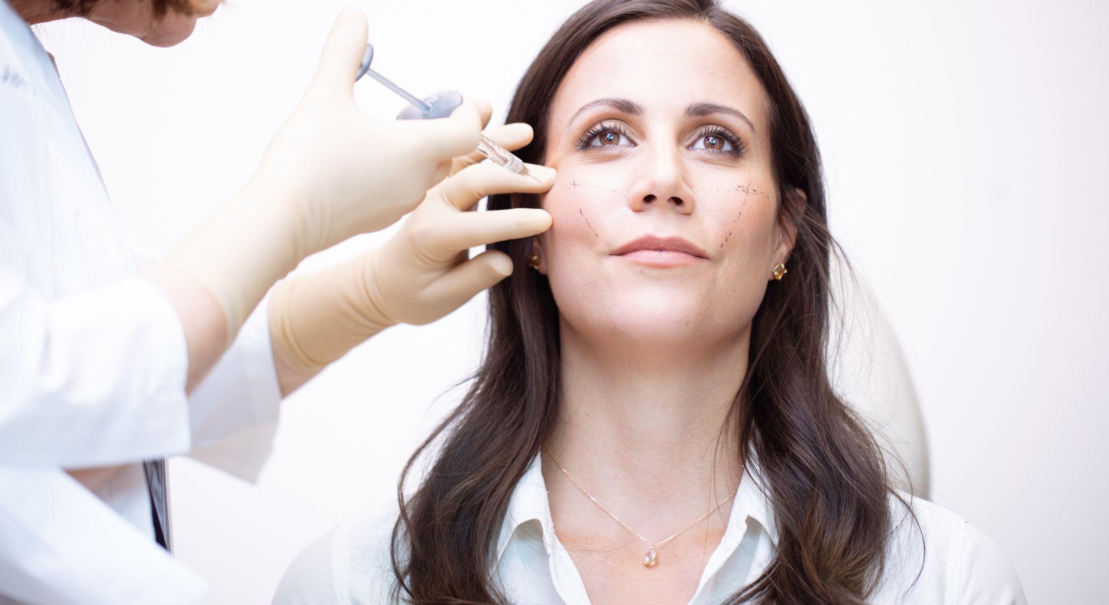 Patient receiving a cosmetic facial treatment.